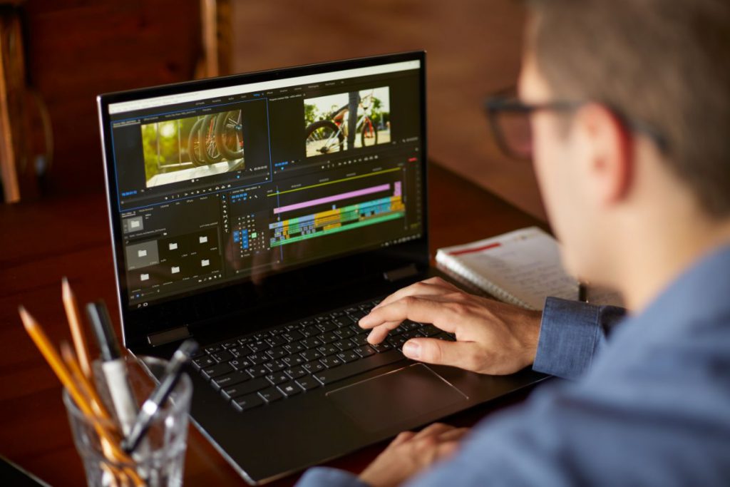 A man editing a video on a laptop