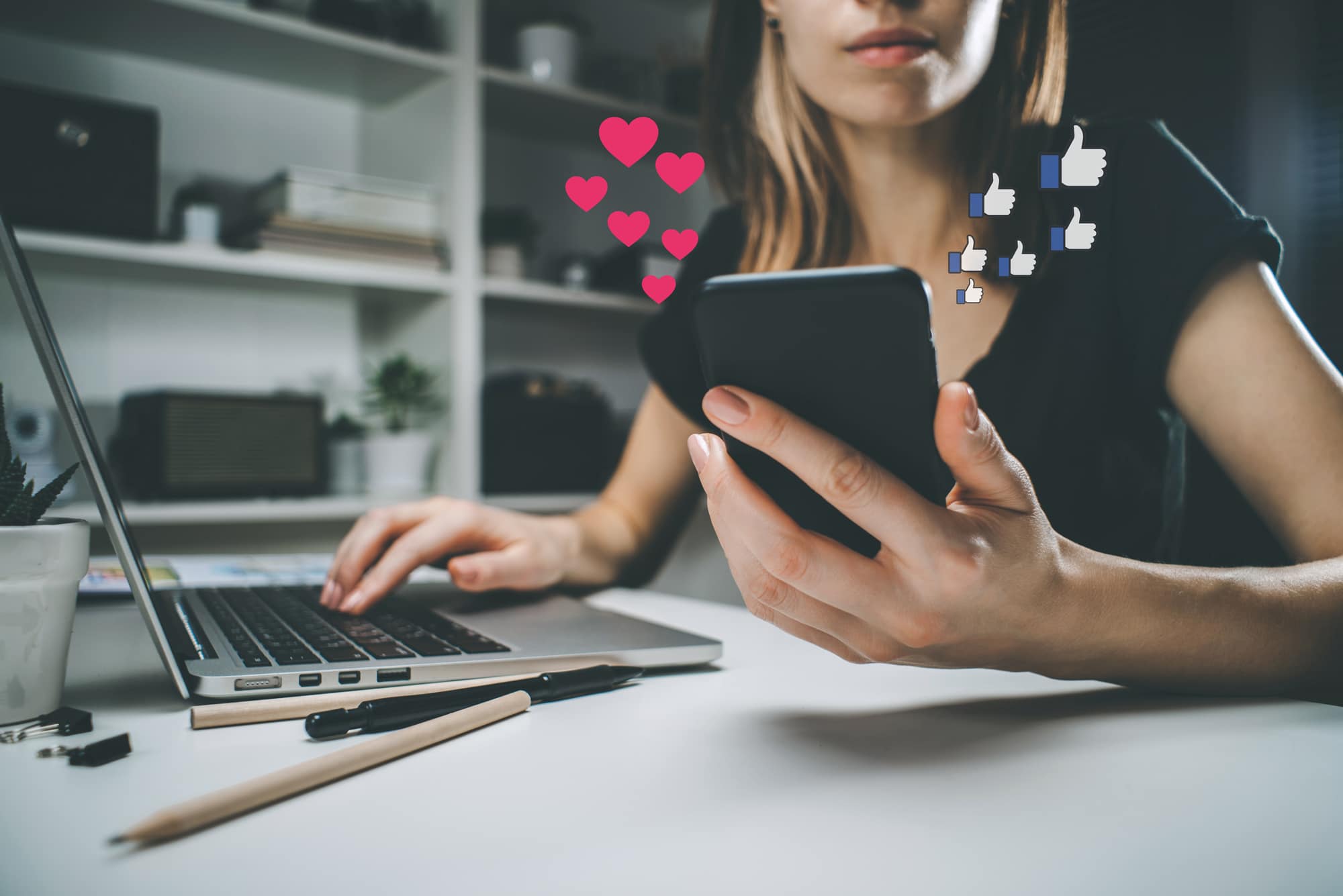 Woman using her phone with likes and hearts floating above it